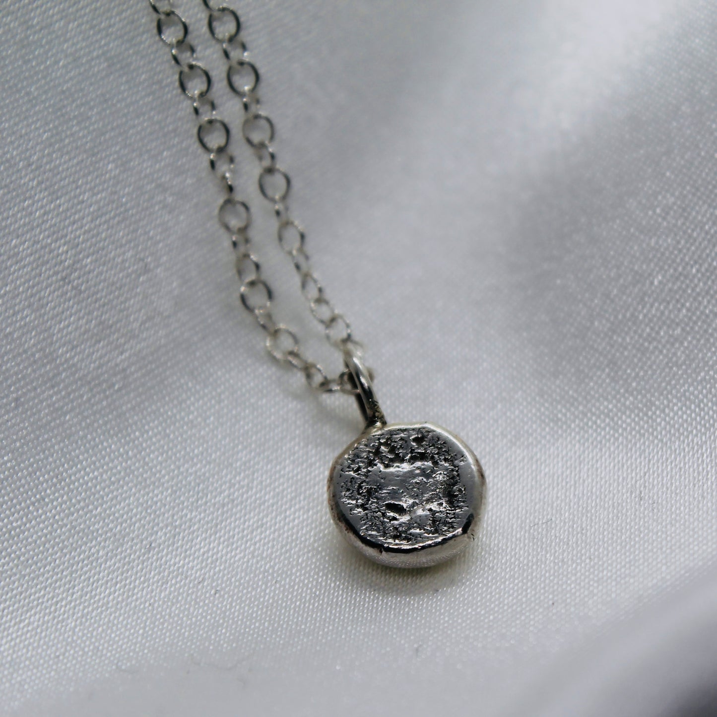 Double sided ‘molten silver’ pendant